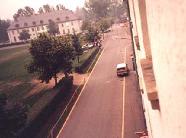 apr1303_TS14.jpg - Todd Stach - E Troop - Daley - 1985 - As First Sergeant John's car departs, a look up the street toward the 2-41 FA Dining Facility. 