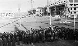 The view from the platform as the workers assemble. Note various stages of completion of other buildings. The view from the platform as the workers assemble. Note various stages of completion of other buildings.